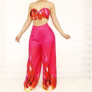 A hot pink two-piece pant set features an edgy flame print.